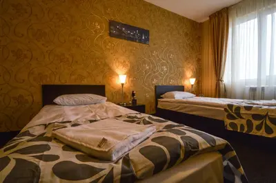 a hotel room with two beds and a window at Elite Spetema Hotel in Sofia