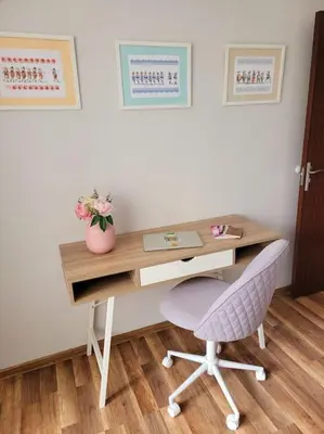 a desk with a chair and a vase of flowers at Plovdiv Top Center 2 Bedroom Apartment, FREE Parking in Plovdiv