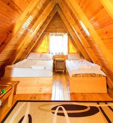 two beds in a room in a tree house at Romantica Forest Guest House in Dospat