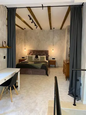 a bedroom with a bed and a desk in it at Courthouse Apartments Slavi in Sofia