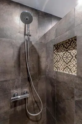 a shower with a hose in a bathroom at 66 Apartment - Stylish Two Bedroom in Lozenets District by Flat Mаnager in Sofia