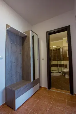 a bathroom with a toilet and a glass door at Apartment IVA - Iglika 2 in Borovets