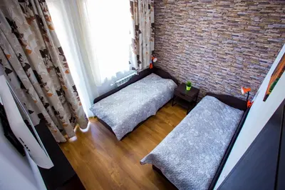 a room with two beds and a brick wall at Apartment IVA - Iglika 2 in Borovets