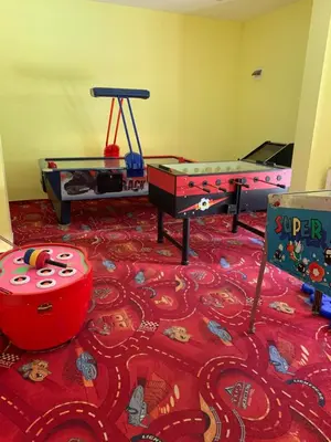 a room with play equipment and ping pong tables at Studios-Villa Park SV in Borovets