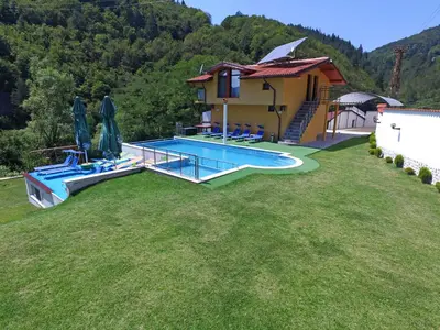 a large yard with a swimming pool and a house at Къща за гости Суни Транс in Smolyan