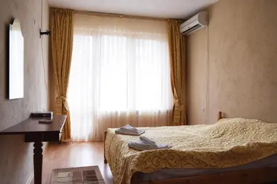 a hotel room with a bed and a window at СТАИ ЗА ГОСТИ МЗ-ДЕВИН in Devin