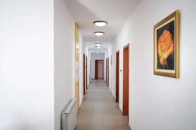 a hallway with white walls and a painting on the wall at СТАИ ЗА ГОСТИ МЗ-ДЕВИН in Devin
