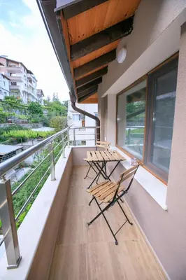 two chairs and a table on the balcony of a building at Апартаменти Принц и Принцеса in Sandanski