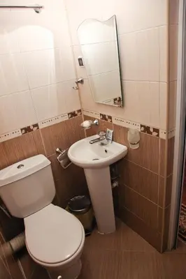a bathroom with a toilet and a sink and a mirror at Rio Family Hotel in Blagoevgrad