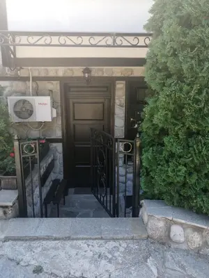 a entrance to a house with a black door at Petkov Family Hotel in Blagoevgrad