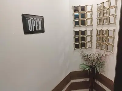 a sign on a wall with a vase of flowers at Petkov Family Hotel in Blagoevgrad