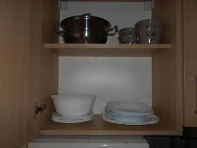 a shelf with plates and pots and pans in a kitchen at NICE STUDIO in 