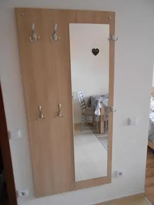 a wooden door with a mirror in a room at NICE STUDIO in 