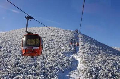 a ski lift going up a snow covered mountain at NICE STUDIO in 