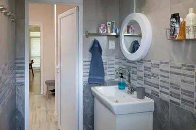 a bathroom with a sink and a mirror at Bright and Cozy 2BD Flat in Plovdiv City Centre by Flat Mаnager in Plovdiv
