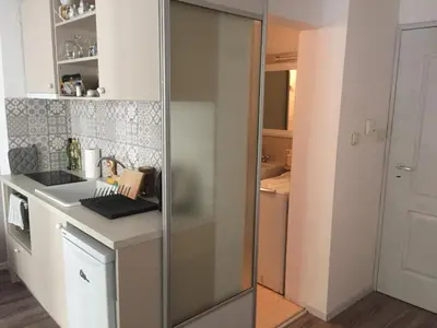 a kitchen with a glass door in a kitchen at Apartment Button in downtown in Sofia
