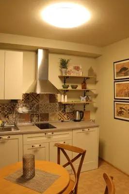 a kitchen with a table and a stove top oven at Urban House in Sofia