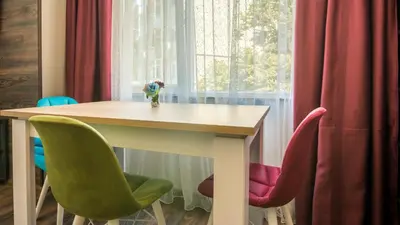 a table and chairs in a room with a window at The old Bakery Apartments in Plovdiv