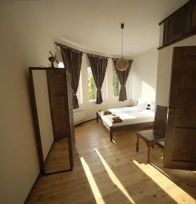 a bedroom with a mirror and a bed in a room at The FlyingTheatre Suites in Plovdiv
