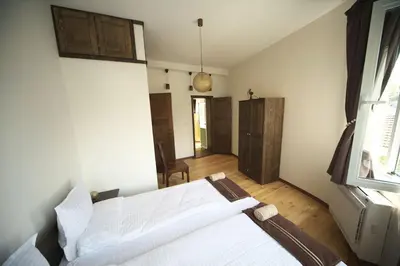 a bedroom with a white bed and a window at The FlyingTheatre Suites in Plovdiv
