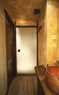 a bathroom with a white door and a sink at The FlyingTheatre Suites in Plovdiv