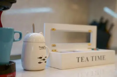 a tea timer sitting on a counter next to a box at The Place -Apartments in Plovdiv, with private parking in Plovdiv