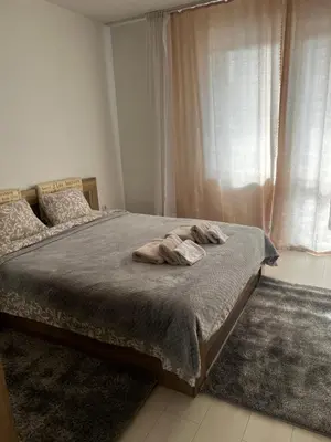 a bedroom with a bed with two towels on it at The Place -Apartments in Plovdiv, with private parking in Plovdiv
