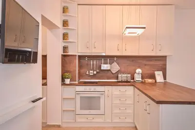 a kitchen with white cabinets and a stove top oven at South Park, Vitosha View, 2-BDR, 2-BTHR Apartment by Flat Mаnager in Sofia