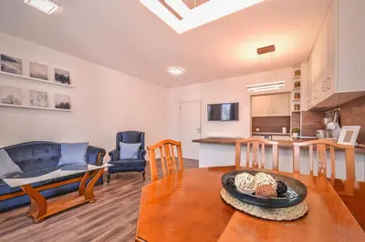 a living room with a table and a kitchen at South Park, Vitosha View, 2-BDR, 2-BTHR Apartment by Flat Mаnager in Sofia