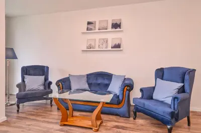 a living room with two chairs and a table at South Park, Vitosha View, 2-BDR, 2-BTHR Apartment by Flat Mаnager in Sofia