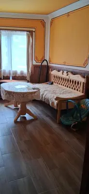 a bedroom with a bed and a wooden table at Стаи за гости Дончо Войвода in Koprivshtitsa