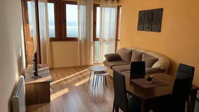 a living room with a couch and a table at Private Apartment Maxim in Bansko