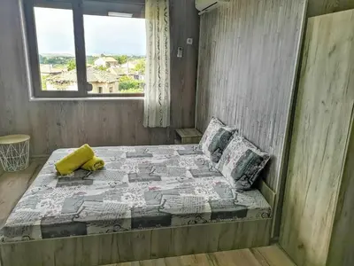 a bedroom with a bed with a teddy bear on it at Bali Petrich in Petrich