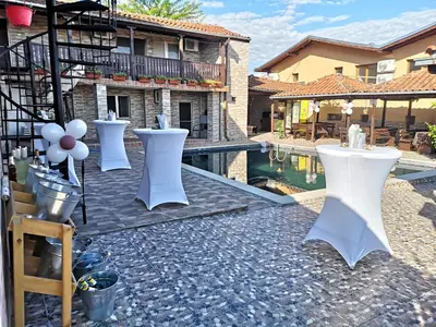 a group of white tables and chairs next to a pool at Bali Petrich in Petrich