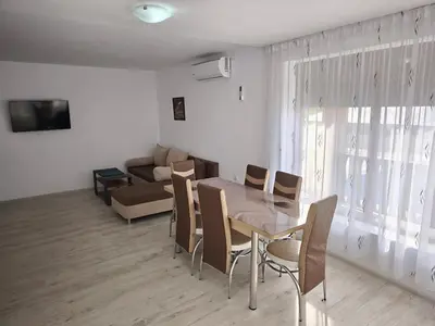 a living room with a table and chairs and a couch at Bali Petrich in Petrich