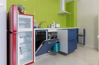 a kitchen with blue cabinets and a red refrigerator at Pop your COLORS - Funky and Modern 1BDR Apt by Flat Mаnager in Plovdiv