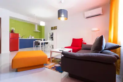 a living room with a couch and a table at Pop your COLORS - Funky and Modern 1BDR Apt by Flat Mаnager in Plovdiv