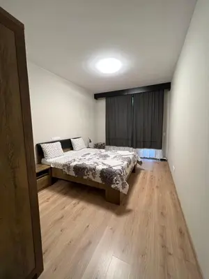 a bedroom with a bed and a wooden floor at Business and Leisure apartments in Mladost 2 with FREE Garage in Sofia