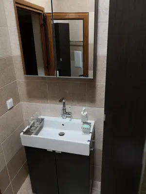 a bathroom with a white sink and a mirror at Business and Leisure apartments in Mladost 2 with FREE Garage in Sofia