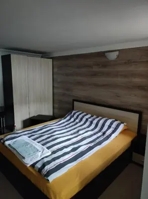 a bed with a striped blanket on it in a room at Marchevi in the Old Town in Plovdiv
