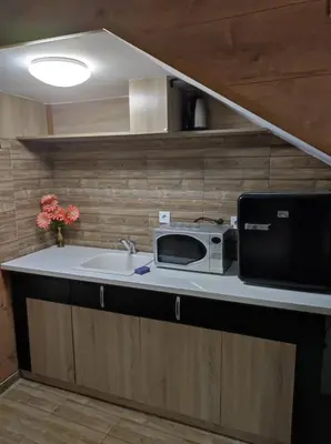 a kitchen with a sink and a microwave on a counter at Marchevi in the Old Town in Plovdiv