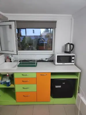 a kitchen counter with a microwave and a window at Marchevi in the Old Town in Plovdiv