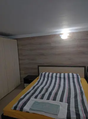 a bedroom with a bed with a wooden wall at Marchevi in the Old Town in Plovdiv