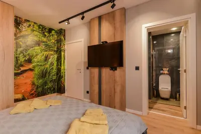 a bedroom with a bed with a painting on the wall at Urban Eden - LUX & STYLE, 2-Bedroom, 2-Bathroom in Sofia