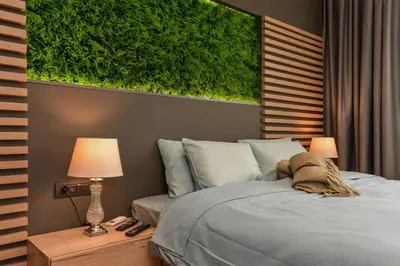 a bedroom with a bed with a green painting on the wall at Urban Eden - LUX & STYLE, 2-Bedroom, 2-Bathroom in Sofia