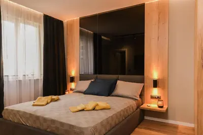a bedroom with a bed with two towels on it at Urban Eden - LUX & STYLE, 2-Bedroom, 2-Bathroom in Sofia