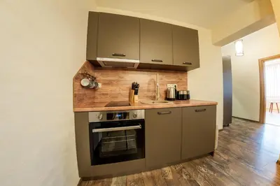 a kitchen with gray cabinets and a stove at Sofia Crown Life Apartment in Sofia