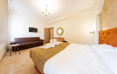 a bedroom with a bed with a towel animal on it at Sofia Crown Life Apartment in Sofia