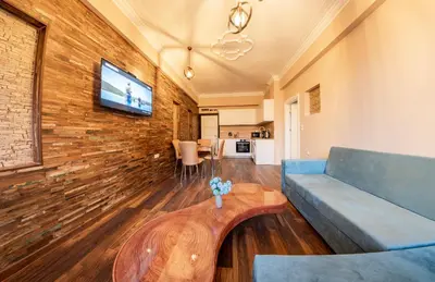 a living room with a blue couch and a table at Sofia Artist Life Apartment in Sofia