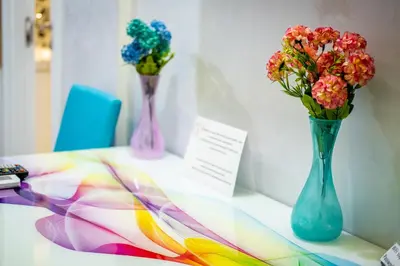 three vases with flowers sitting on a table at Sofia Colour Life Apartment -No Window Apartment in Sofia